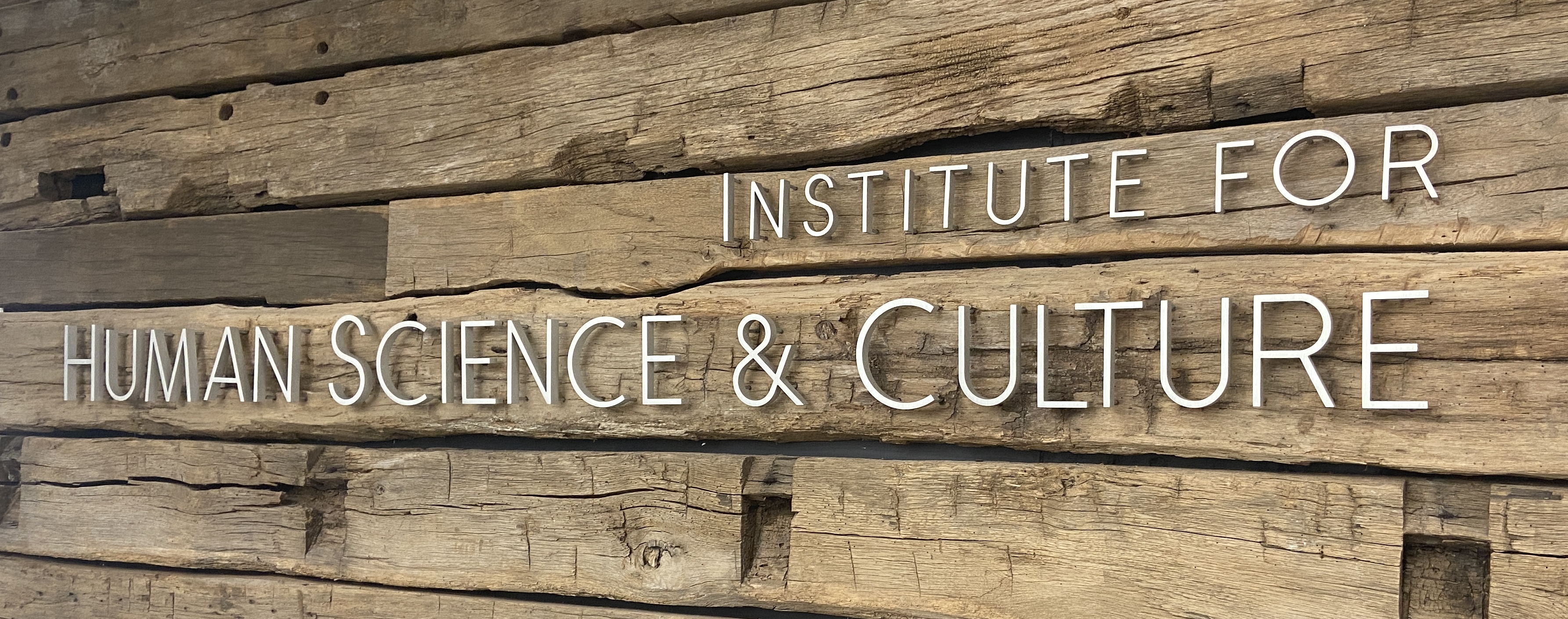 Institute for Human Science and Culture logo displayed on a wall